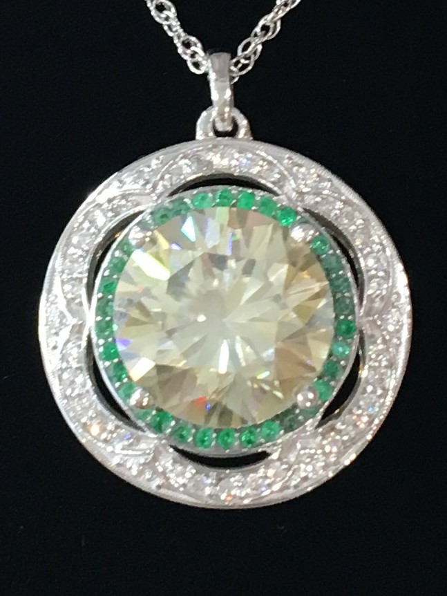 Diamond necklace with emerald halo